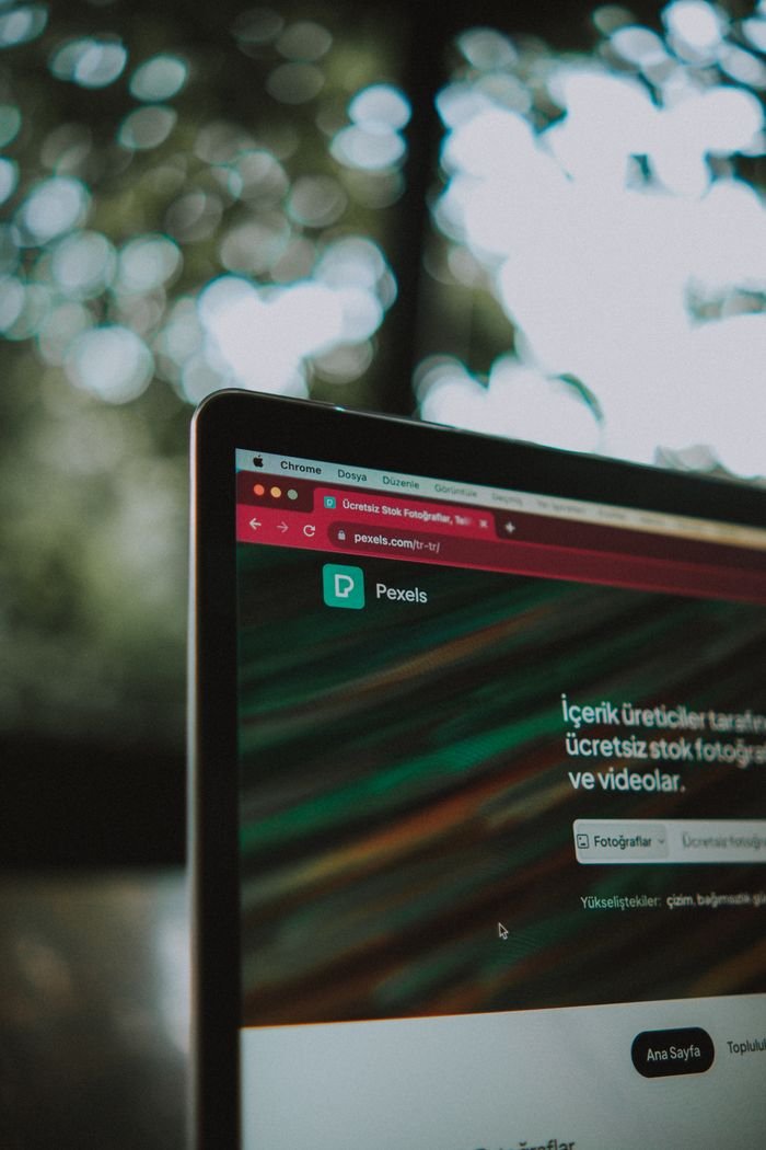 Home Close-up of a laptop screen with the Pexels website open, showcasing a vibrant bokeh background.